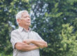 Portrait of an elderly Asian man with short gray hair smiling an