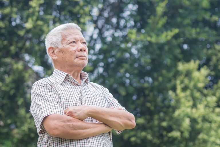 Portrait of an elderly Asian man with short gray hair smiling an Portrait of an elderly Asian man with short gray hair smiling an