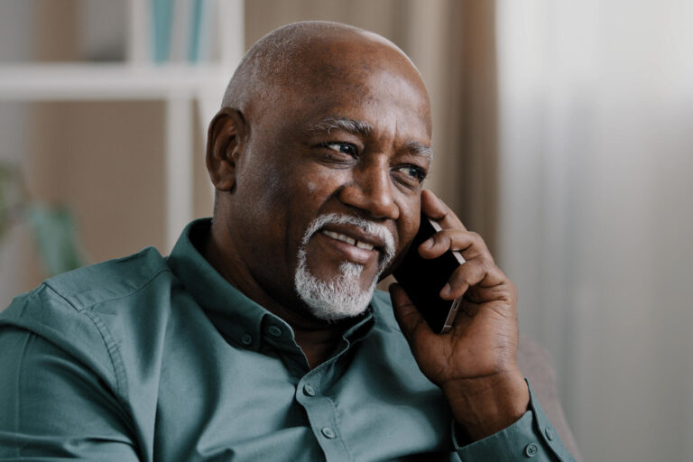 African middle aged business man senior mature businessman entrepreneur at home in office talking phone chatting mobile conversation booking order with smartphone call discussing remote talk speaking African middle aged business man senior mature businessman entrepreneur at home in office talking phone chatting mobile conversation booking order with smartphone call discussing remote talk speaking