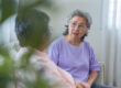Two happy cheerful elderly aged female friends relaxing together