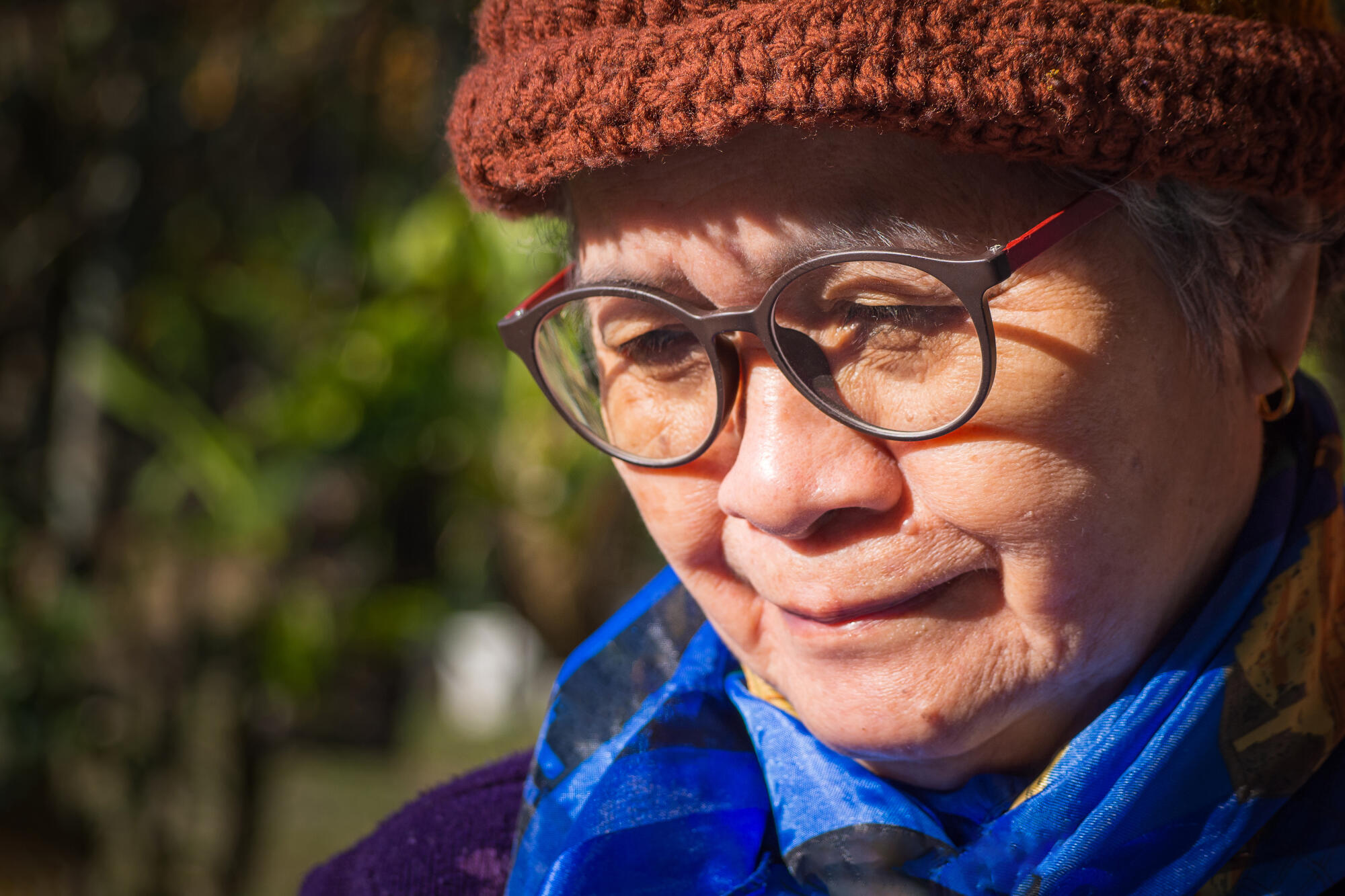 Portrait of a happy senior woman smiling and looking down while Portrait of a happy senior woman smiling and looking down while