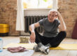 Elderly man relaxing after his fitness workout at home
