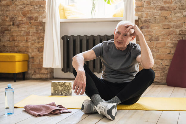 Elderly man relaxing after his fitness workout at home Elderly man relaxing after his fitness workout at home