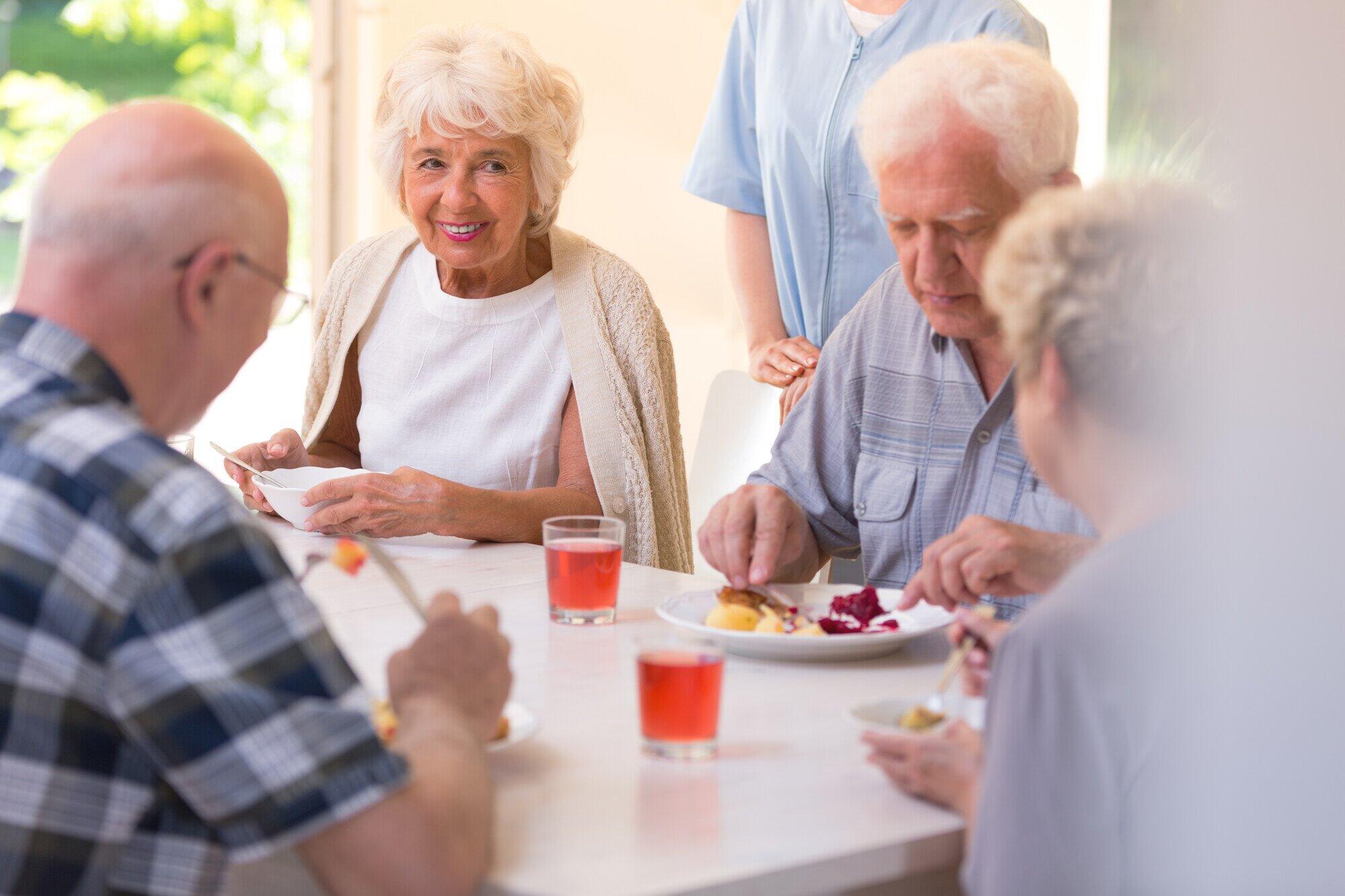 Group of pensioners eating lun