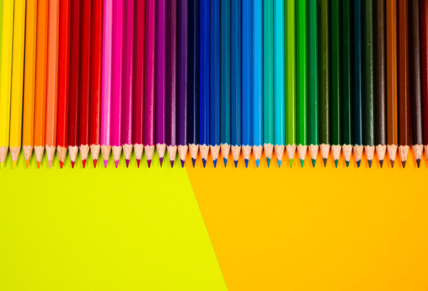 multi colored pencils on multi colored background, Close up, copy space, Modern art. Modern design multi colored pencils on multi colored background, Close up, copy space, Modern art. Modern design