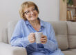 Comfort relaxed senior old elderly woman grandmother drinking ho