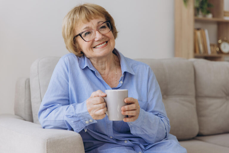 Comfort relaxed senior old elderly woman grandmother drinking ho