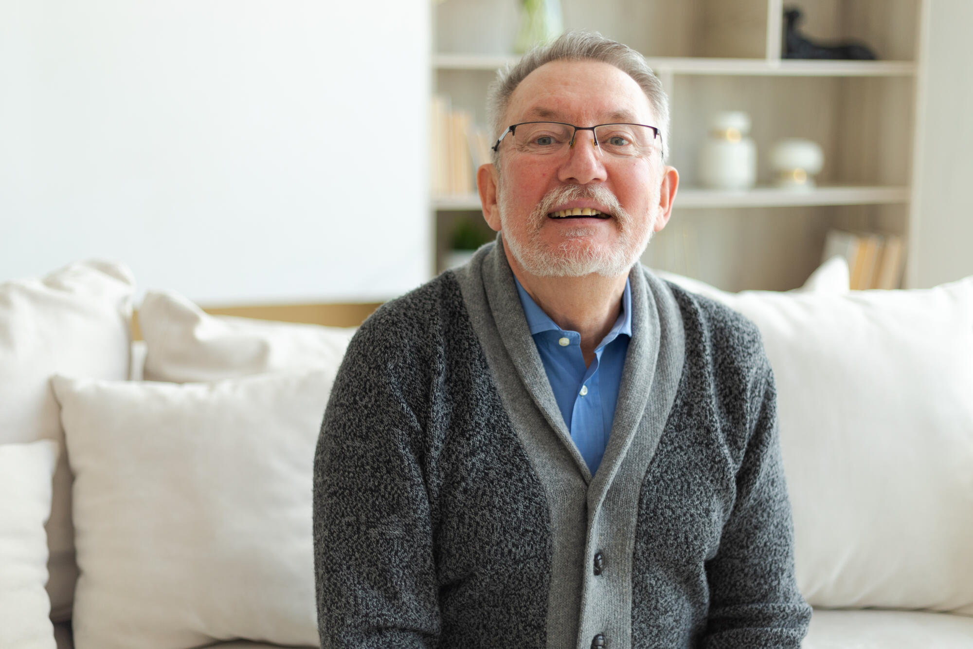 Confident stylish middle aged senior man at home. Older mature 70s man smiling. Happy attractive senior beard grandfather looking camera close up face headshot portrait. Happy people.