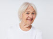 close up of a cheerful elderly woman in a white t shirt