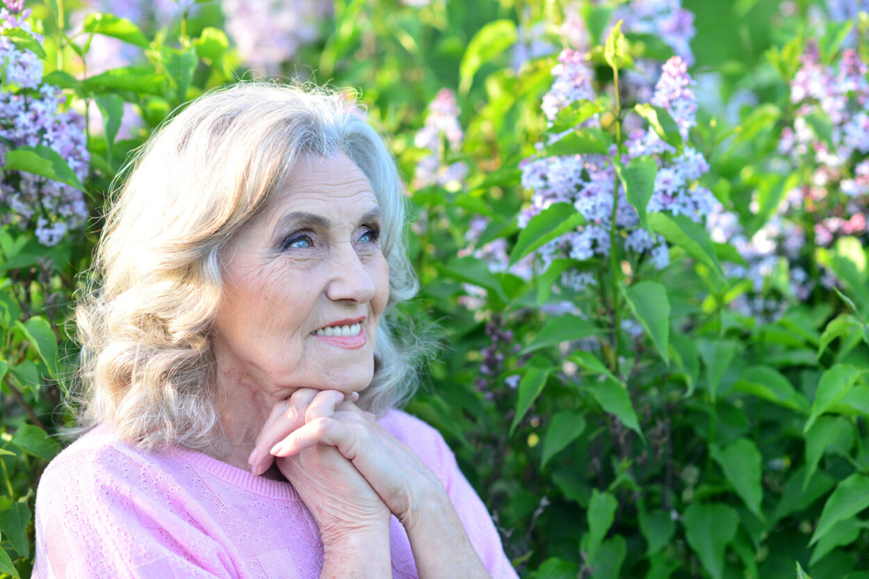 Portrait of a beautiful elderly woman in the park