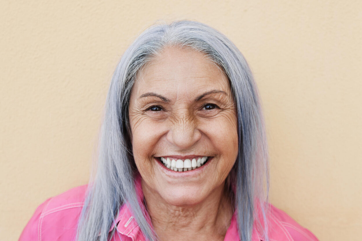 Portrait,Of,Happy,Senior,Woman,Smiling,On,Camera,Outdoors,With