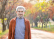 portrait healthy senior man walking along the street outdoors in autumn