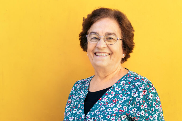 Cheerful old woman on yellow background Cheerful old woman on yellow background