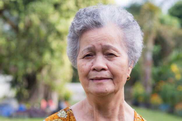 Portrait of a senior woman with short gray hair smiling and look