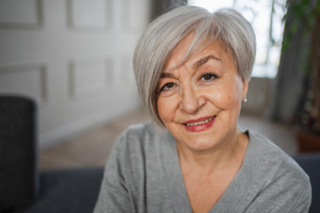 Portrait of confident stylish european middle aged senior woman. Older mature 60s lady smiling at home. Happy attractive senior female looking camera close up face headshot portrait. Happy people.