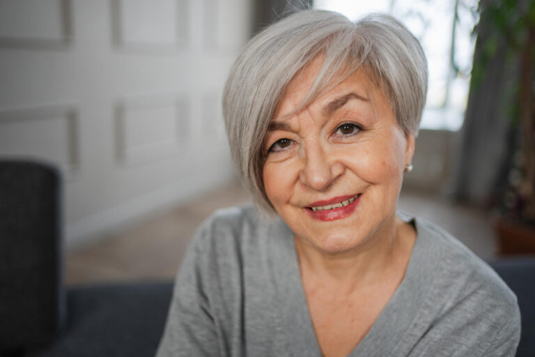 Portrait of confident stylish european middle aged senior woman. Older mature 60s lady smiling at home. Happy attractive senior female looking camera close up face headshot portrait. Happy people.