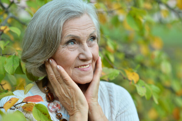 Portrait of senior woman in summer park