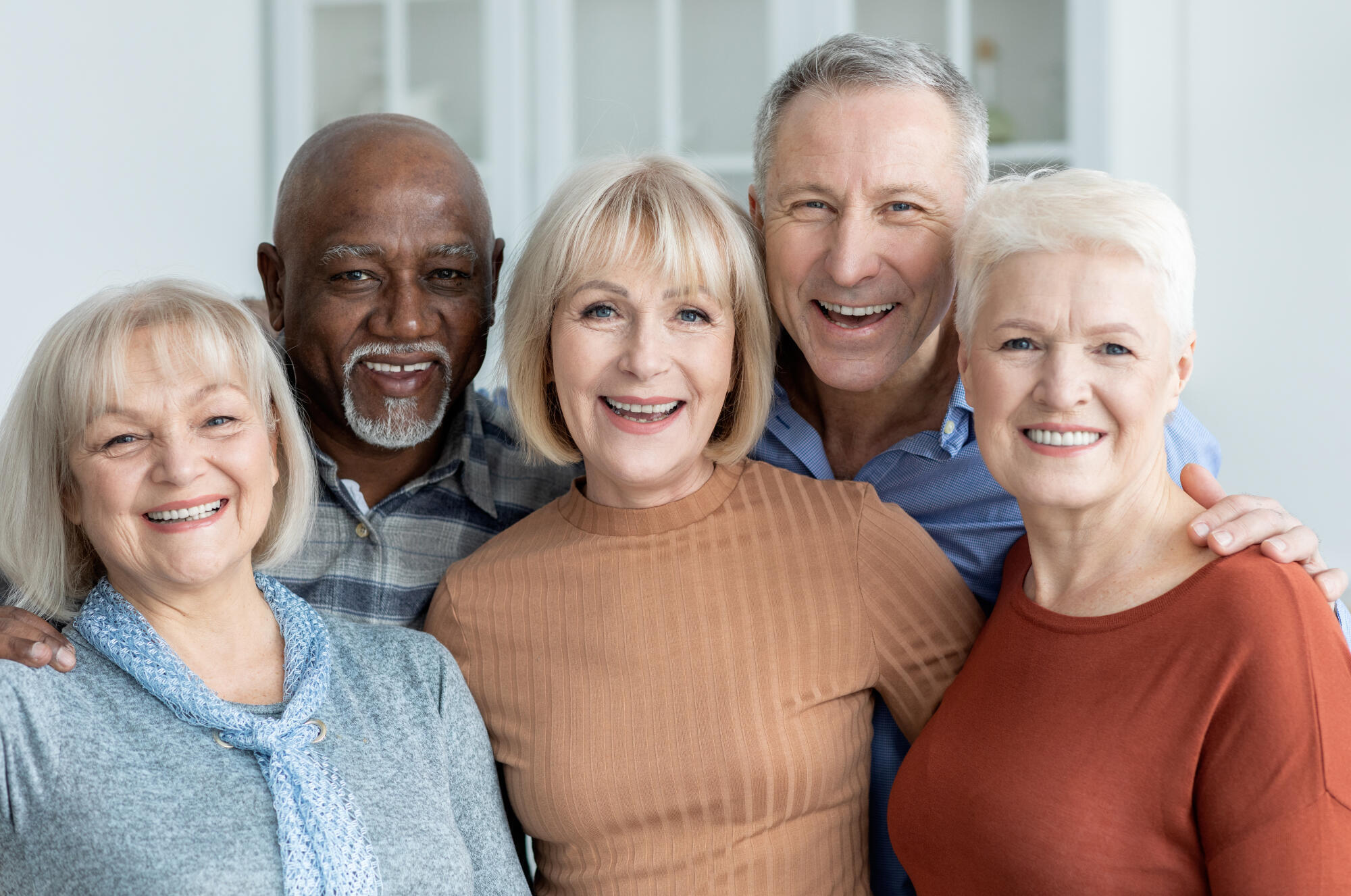 Portrait of multiracial group of senior people friends posing together