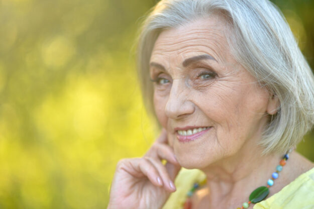 Close up portrait of happy smiling senior woman in park Close up portrait of happy smiling senior woman in park