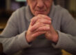 Unrecognizable,Senior,Man,At,Home,Praying,,Hands,Clasped,Togethe