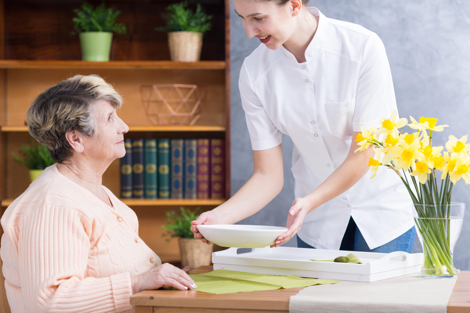 Caregiver,Serving,Nutritious,Soup,To,Senior,Lady