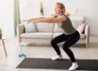 Home training concept. Active mature lady doing squats on yoga mat indoors, copy space