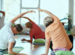 Senior Women Embrace Wellness: Yoga and Stretching in a Sunlit Space
