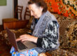 Elder woman using a laptop computer at home