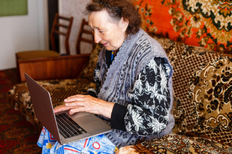 Elder woman using a laptop computer at home