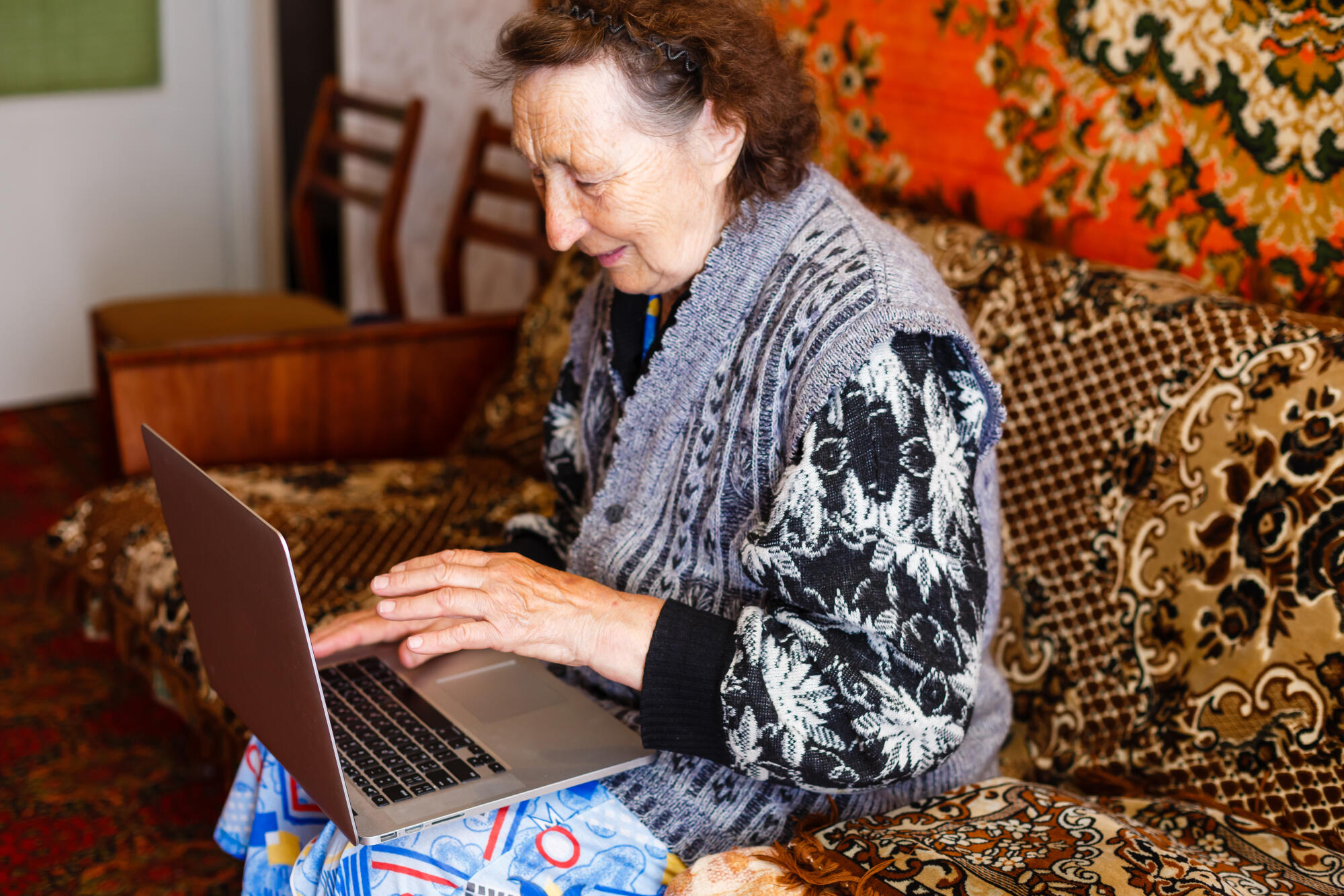 Elder woman using a laptop computer at home