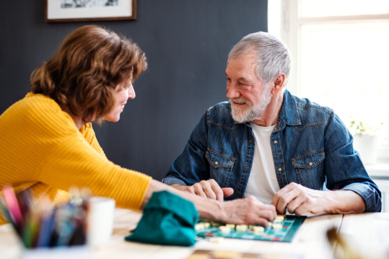 Senior,Couple,Playing,Board,Games,In,Community,Center,Club. Senior,Couple,Playing,Board,Games,In,Community,Center,Club.