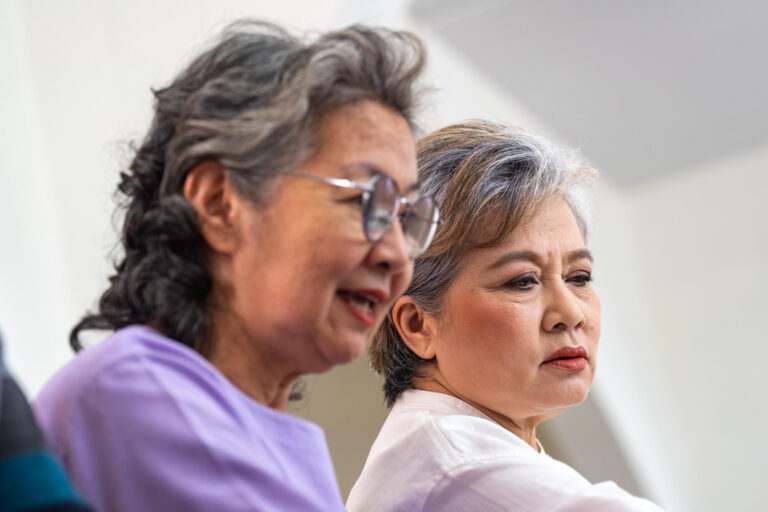 close up senior females and male sitting on bench. older people close up senior females and male sitting on bench. older people