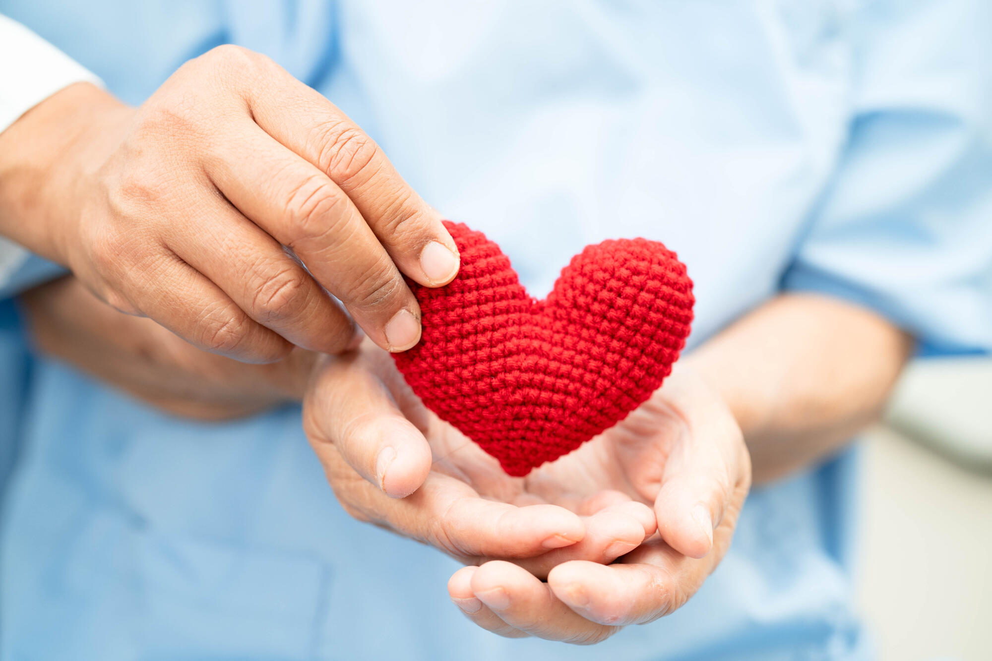 Asian elder senior woman patient holding red heart in hospital. Asian elder senior woman patient holding red heart in hospital.