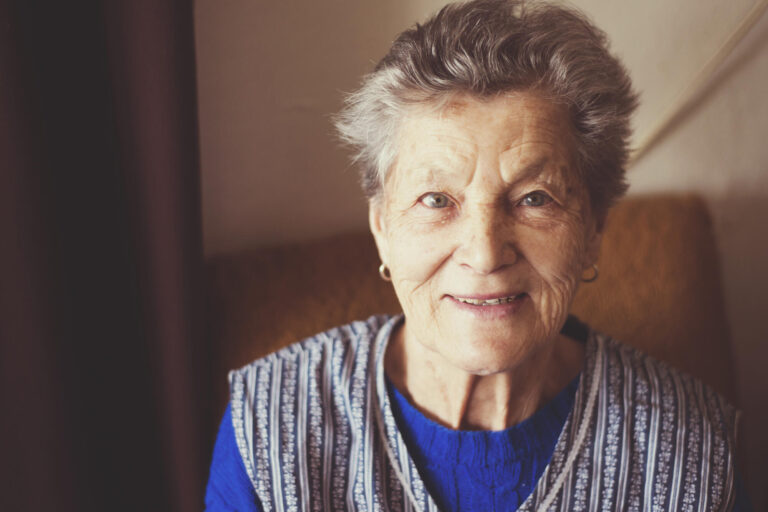 Portrait,Of,Senior,Woman,Sitting,In,Armchair,At,Home