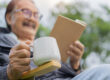 Close up hand of senior man holding a cup of coffee while restin