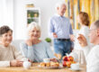 Senior,People,Visiting,Old,Friends,At,Home,Sitting,Together,At