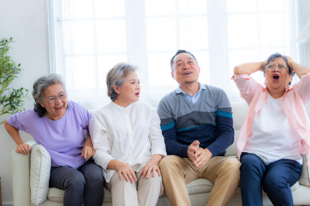 Happiness of the group females and male elderly sitting on the s
