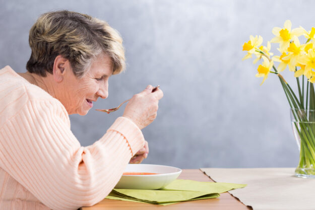 Senior,Woman,Sitting,Beside,Table,,Eating,A,Soup Senior,Woman,Sitting,Beside,Table,,Eating,A,Soup