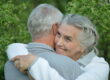 Beautiful elderly couple hugging in the park