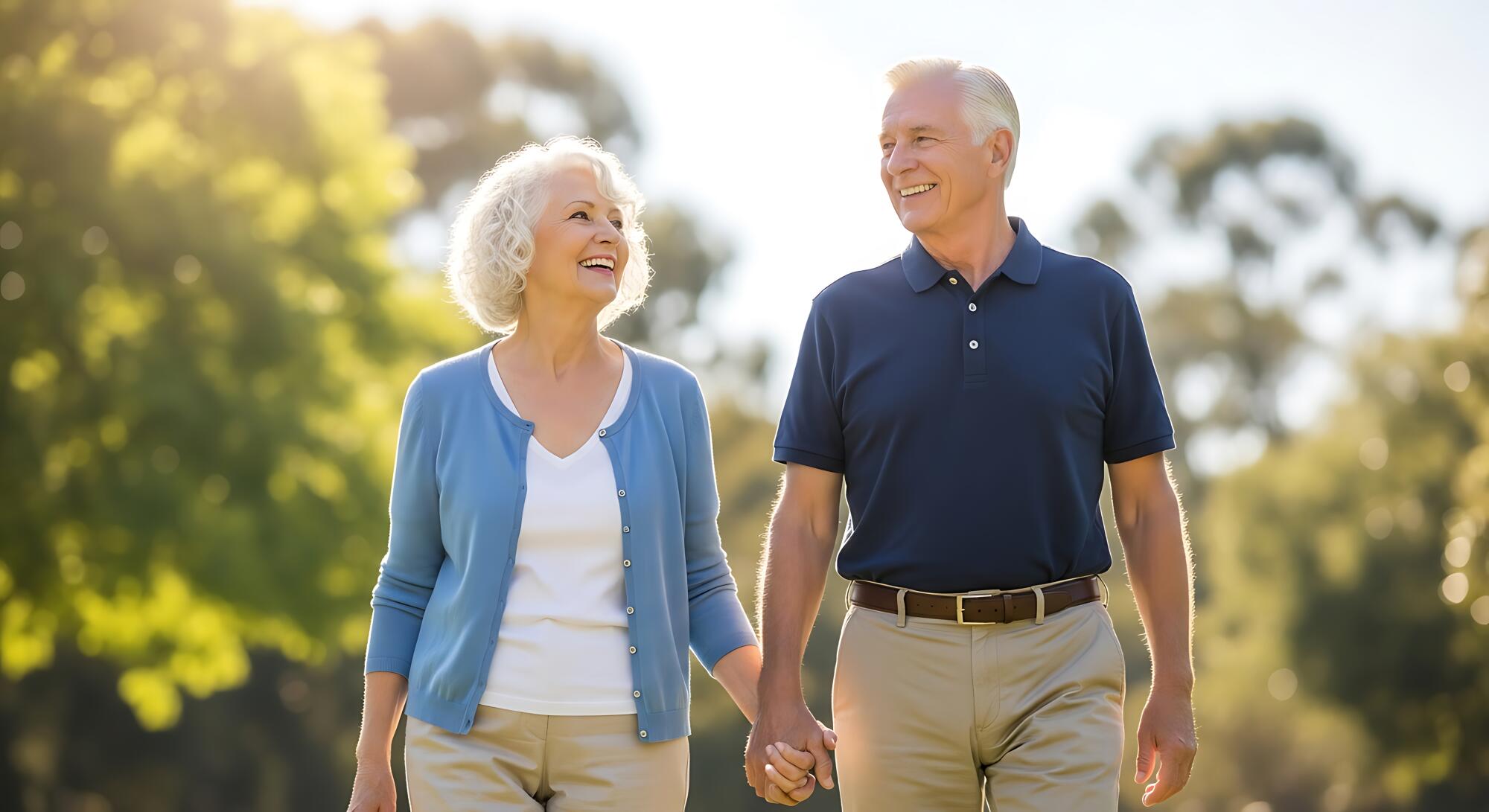 Senior couple enjoying a joyful walk in a sunlit park, surrounded by lush greenery and trees Senior couple enjoying a joyful walk in a sunlit park, surrounded by lush greenery and trees